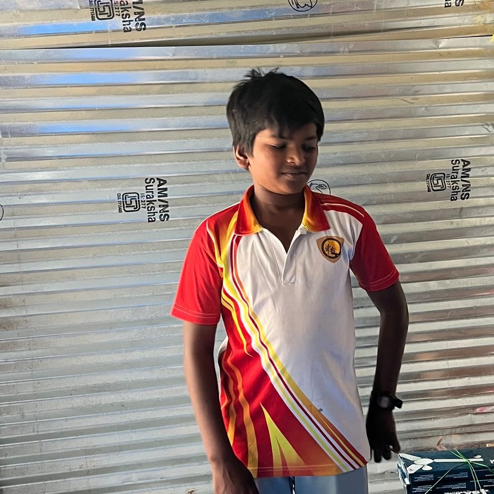 A boy speaking in front of the class at Spoken English